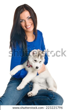 playing woman with puppies of siberian haski on white background