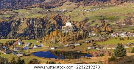 Panorama of the valley with the Tarasp Castle in autumn splendid color from a high view