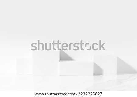White template for product presentation made with white square podiums on white background in sunlight. Trendy fashion showcase mockup.