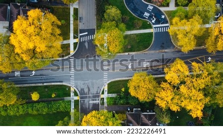 Fall colors in a suburban intersection Royalty-Free Stock Photo #2232226491