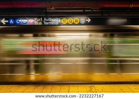  subway train passes by in motion blur.