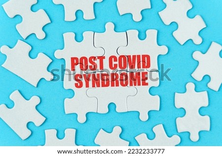 Medical concept. On a blue background are white puzzles with the inscription - Post covid syndrome Royalty-Free Stock Photo #2232233777