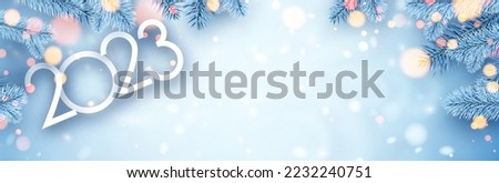 2023 sign with fir on blue background with yellow bokeh. Space for text. Vector holiday illustration.