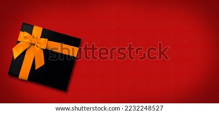 
christmas red background with gift box with yellow ribbon