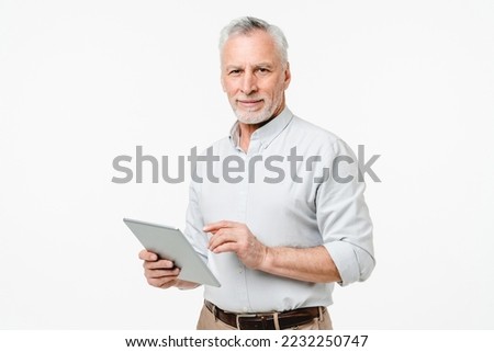 Smart caucasian mature middle-aged senior freelancer grandfather ceo boss teacher professor using digital tablet for remote work online, watching webinars isolated in white background Royalty-Free Stock Photo #2232250747