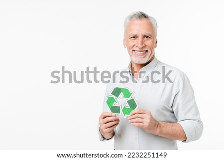 Cheerful caucasian elderly senior man volunteer eco-activist holding recycling logo sign for zero waste lifestyle, garbage sorting, plastic pollution concept isolated in white background