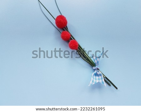 Artificial flower on blue background.