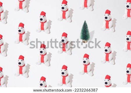 Plush toy polar bear with christmas tree pattern. White background.
