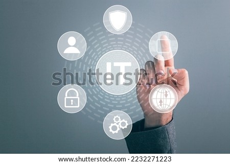 IT and icons on a virtual screen. Information technology. Man tapping on the screen