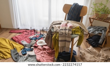 Lots of clothes and a messy room.A lot of winter clothes. Royalty-Free Stock Photo #2232274157