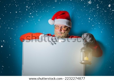 Santa Claus holding white blank banner or copy space for text, Merry Christmas and New Year's Eve concept