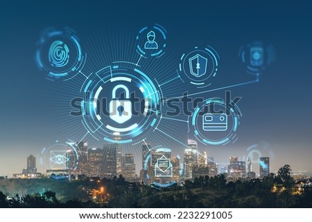 Illuminated Skyline panorama of Los Angeles downtown at night, California, USA. Skyscrapers of LA city. Glowing Padlock hologram. The concept of cyber security to protect confidential information