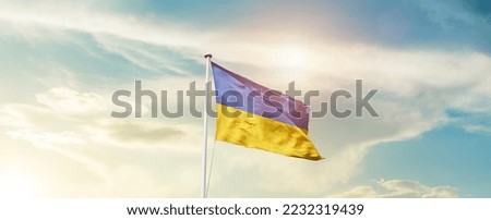 Ukraine national flag waving in beautiful sky.