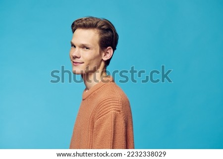 horizontal portrait of a cute smiling guy on a blue background