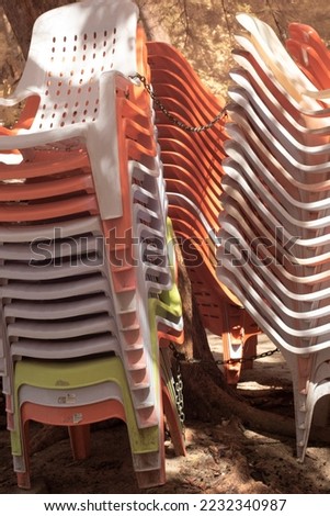 infrared image of the lots of stacked up plastic air chair at the park