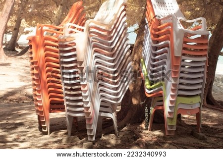 infrared image of the lots of stacked up plastic air chair at the park