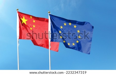 China flag and EU flag on cloudy sky. Waving in the sky