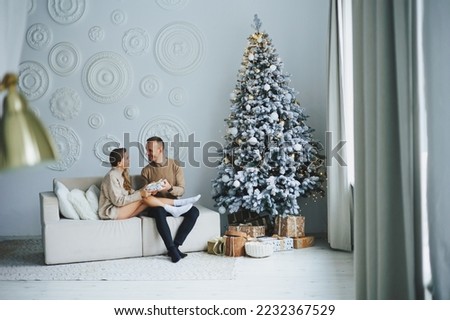 A beautiful couple embraces during a New Year's photo session. Lovers welcome the new year together. A couple in love enjoying each other on New Year's Eve. New Year and Christmas. February 14th.