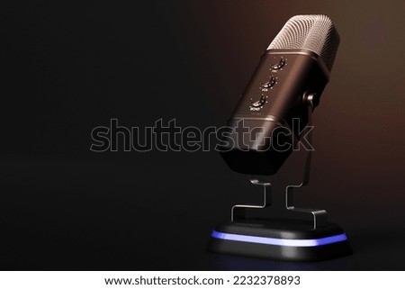 Black retro microphone isolated on a pastel black background. minimal style.