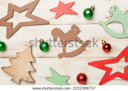 Wooden Christmas toys on color background, top view.