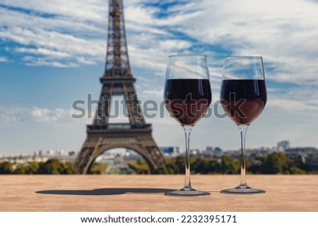 Two glasses of wine on Eiffel tower and Paris skyline background. 