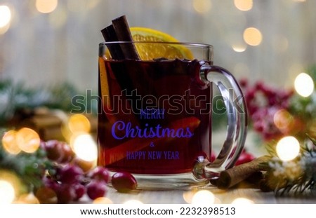 cups with hot mulled wine on a wooden background. New year concept