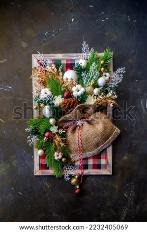 Decoration of a New Year or Christmas in the form of a picture with a fir tree and toys close-up