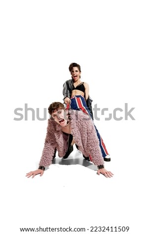 Portrait of stylish young man and woman emotionally posing over white background. Rock and roll performers. Concept of music, rock and roll, lifestyle, fashion. Copy space for ad, text