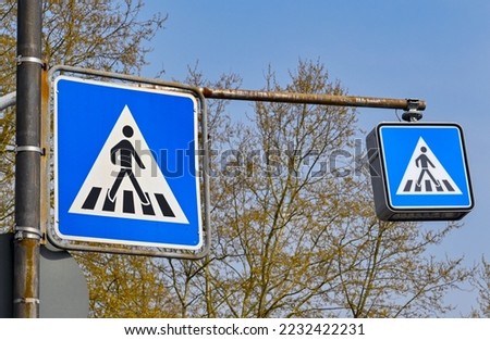 Road signs in Germany warning drivers of a pedestrian crossing ahead