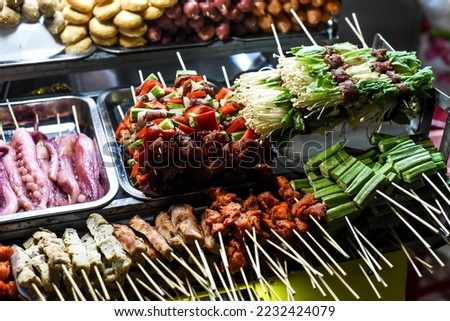 Many snacks and seafood in vietnamese night market in Da Lat Royalty-Free Stock Photo #2232424079