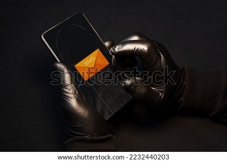 Smishing alert. A cybercriminal sending fraudulent text messages via cell phone to scam vulnerable people. Smishing danger Royalty-Free Stock Photo #2232440203