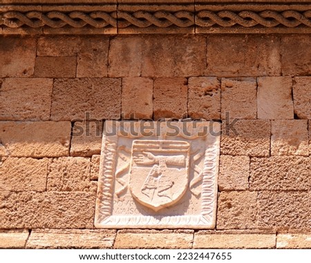 Coats of arms of the Knights of the Order of St. John (Knights of Malta) on the walls of houses in the medieval city of Rhodes on the island of Rhodes.