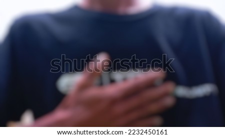 view of man expressing gratitude with hands. defocused and blurred image of male hands in prayer position. practice self-care for well-being.