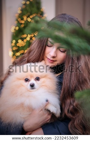 spitz dog and young girl with long hair