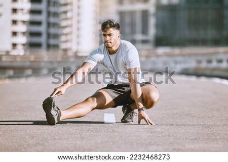 Fitness muscles stretching in city street, young man daily jogging and morning workout training. Physical warmup activity, healthy wellness coaching, sports practice and running for cardio exercise. Royalty-Free Stock Photo #2232468273