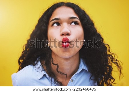 Black woman lips in kiss, red cosmetic lipstick and face closeup on yellow background. Retro aesthetic, young fashion model with funky pose thinking with cool beauty makeup on bright studio wall