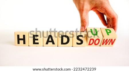 Heads up or down symbol. Concept words Heads up Heads down wooden cubes. Businessman hand. Beautiful white table white background. Business heads up or down concept. Copy space.