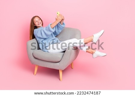 Full body size photo of young teenager schoolgirl popular blogger make video recording online stream chill chair isolated on pink color background