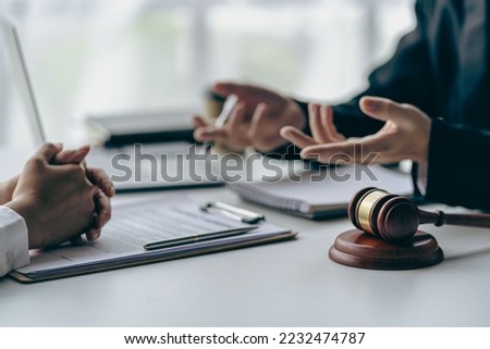 Office with sledgehammer in front, lawyers and clients discussing court issues or justice at meeting Law and order. The concept of courts and legislatures Royalty-Free Stock Photo #2232474787