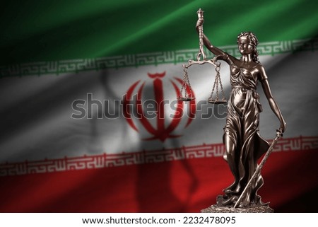 Iran flag with statue of lady justice and judicial scales in dark room. Concept of judgement and punishment, background for jury topics Royalty-Free Stock Photo #2232478095