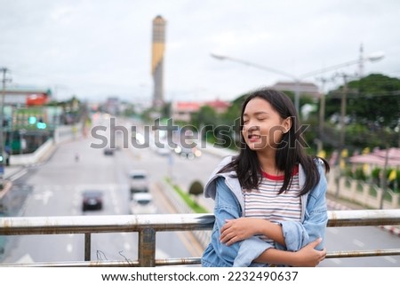 Portrait young girl outdoor with city view.