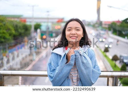 Portrait young girl outdoor with city view.