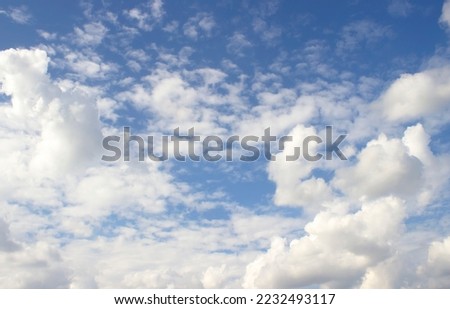 The sky is bright, many white clouds