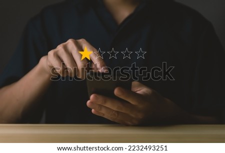 Customer Review Experience Dissatisfied Selection of 1-star rating reviews on smartphone screens. negative feedback concept Unhappy businessman, poor service, or poor quality. Royalty-Free Stock Photo #2232493251