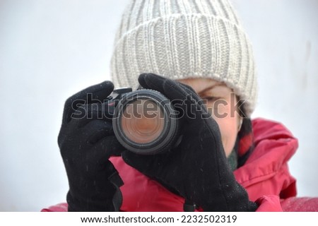 Girl holding a SLR camera in her hands