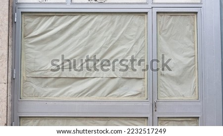 Paper covered shop window glass 