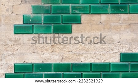 Missing green tiles in outside wall