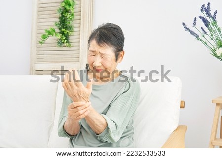 Asian old woman having the joint pain at home