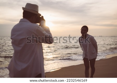 Young couple taking photos with beautiful sea view, Happy people enjoying on beach, Beach therapy, Beach travel