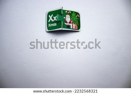 Green color santa claus picture and text puzzle placed on white background
